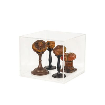 a glass display case with three vases inside of it
