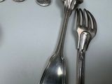 a spoon, fork, and spoon rest on a table