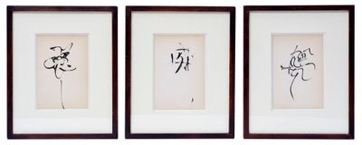 three black and white framed pictures of flowers on a white wall