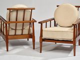 pair of mid - century danish lounge chairs with upholstered cushions