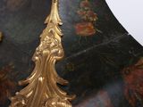 a black and gold vase with a gold decoration on it