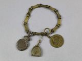 an image of a bracelet with coins and charms on it