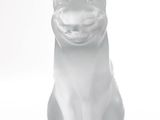 a white cat figurine sitting on a white surface