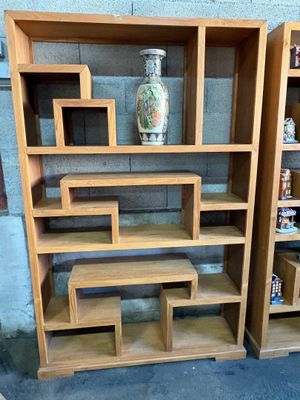 two bookshelves that are next to each other on the floor