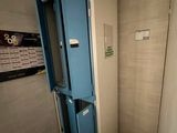 a blue locker in the corner of a bathroom