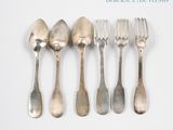 six forks and spoons are lined up on a white surface