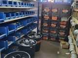 many bins of tools in a large storage room