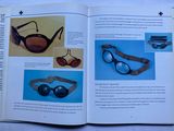 an open book with a picture of sunglasses and other items