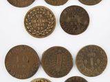 a group of five different coins with the names of different countries