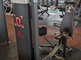 a gym room with a row of machines and other equipment