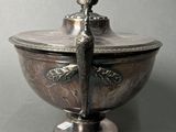 a silver bowl with a lid and a spoon in it