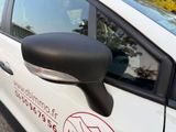 a white car with a red and black sticker on the side of it