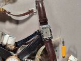 a pile of assorted watches and other watches on a table