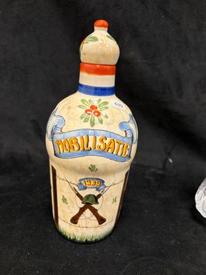 a small bottle with a picture of a man on it