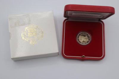 a small red box with a gold coin inside of it