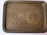 an old brass tray with a decorative design on it