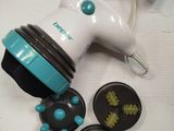 a white and blue hand held hair dryer on a table