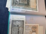 a lot of old money in a folder on the table