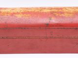an old red box with rust on it on a white surface