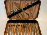 un coffret en bois contenant de l'argenterie sur une surface blanche
