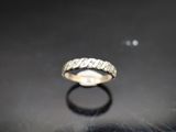 a close up of a diamond ring on a black surface