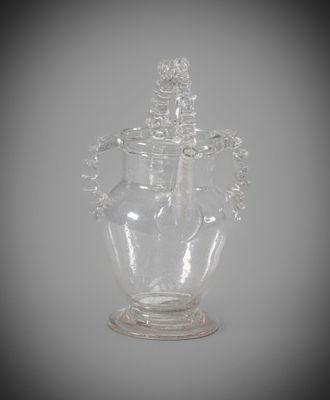 a glass vase with a lid on a table