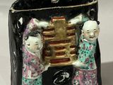 two figurines that are sitting next to each other