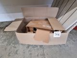 a cardboard box with a sign on it sitting on the floor