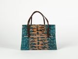 a blue and brown handbag on a white background