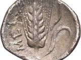 a close up of a silver coin with wheat on it