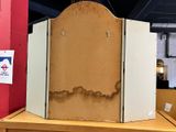 a cardboard screen on a wooden table in a room