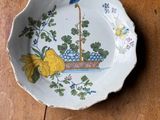 a plate with a bird on it sitting on a table