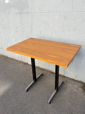 an image of a wooden table with black legs