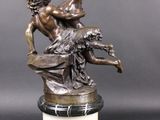 an image of a bronze statue of a man and a woman on a marble base