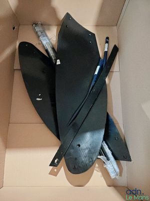 a cardboard box with a pair of skis inside of it
