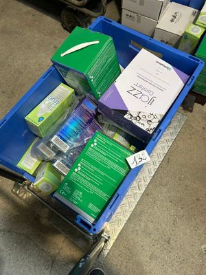 a cart full of boxes and boxes of cleaning supplies
