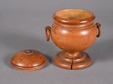a wooden vase and a wooden lid on a table