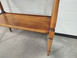a wooden table with a shelf on top of it