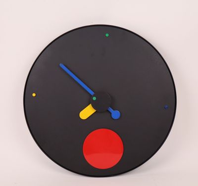 a black clock with a red circle on the face
