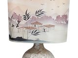 a lamp that is sitting on a table with a lamp shade on it