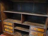 a wooden cabinet with drawers and drawers on it
