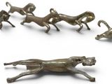 a lot of figurines of dogs running in a circle