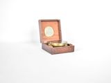 a small wooden box with a coin inside of it