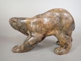 statue of a brown bear on a gray background