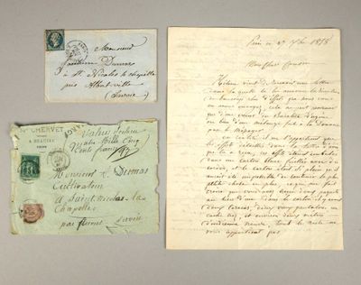 two old letters and a piece of paper on a table