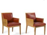 two chairs with red leather upholstered and wooden legs