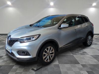 a silver car is parked in a room with a checkered floor