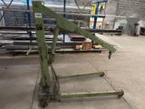 a large green machine that is sitting in a warehouse