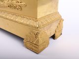 a gold clock sitting on top of a white table