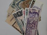 a pile of money sitting on a table next to a cell phone